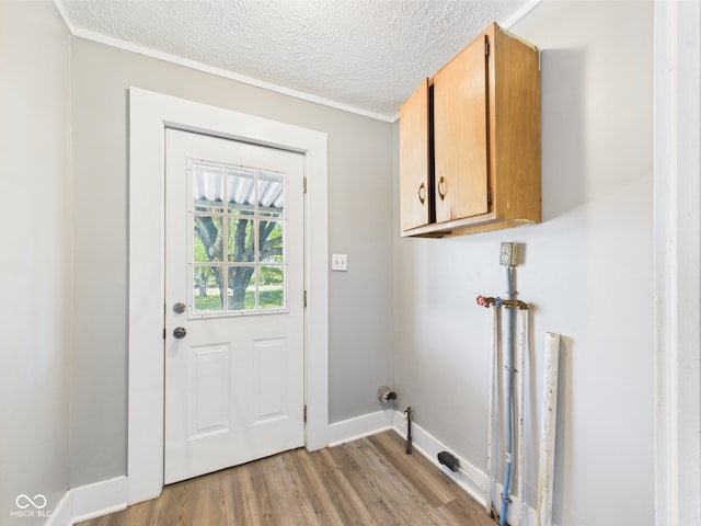 3631 Columbus Ave, Anderson, IN 46013 - washroom with cabinet space, light wood-style floors, baseboards, and a textured ceiling