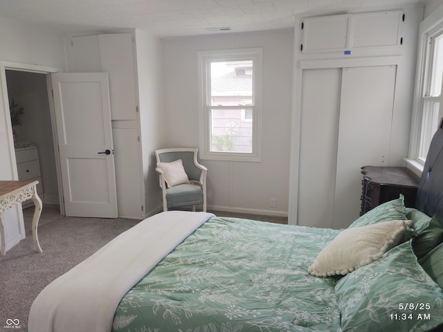 bedroom with carpet floors and baseboards