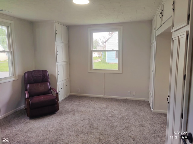 unfurnished room with light carpet, healthy amount of natural light, and baseboards