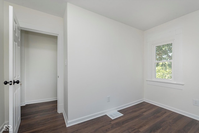 2442 Guilford Ave, Indianapolis, IN 46205 - unfurnished bedroom featuring dark wood-type flooring and baseboards