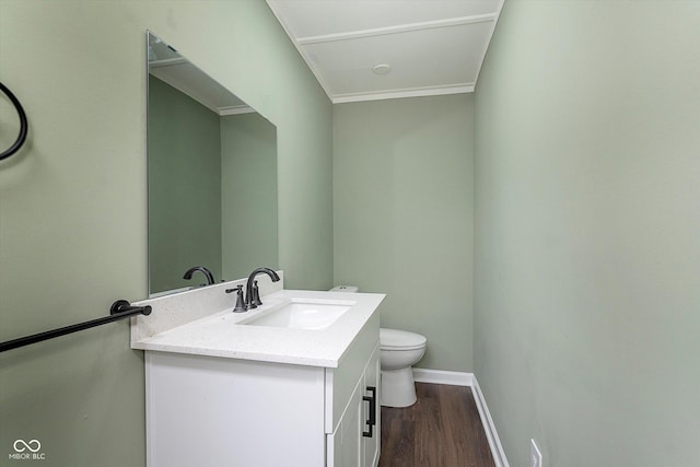 2442 Guilford Ave, Indianapolis, IN 46205 - half bathroom featuring baseboards, vanity, wood finished floors, and toilet