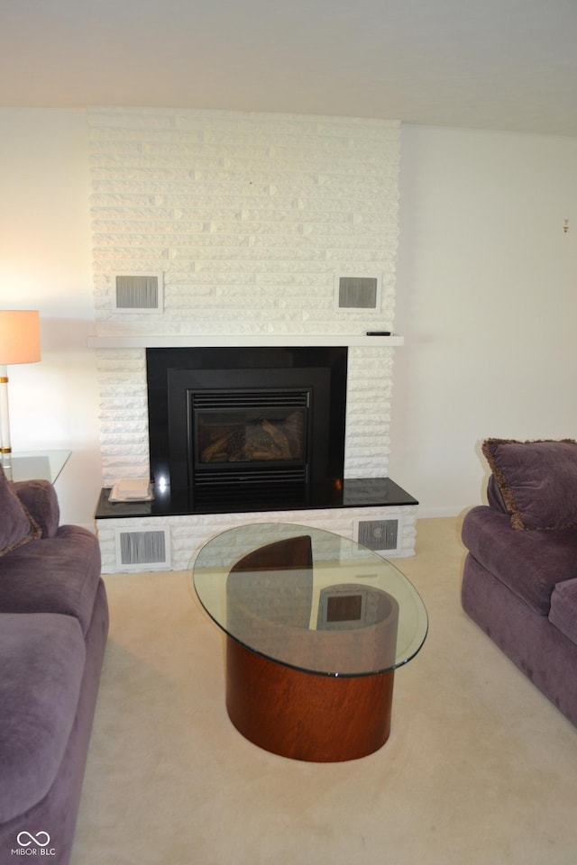 carpeted living area featuring a fireplace
