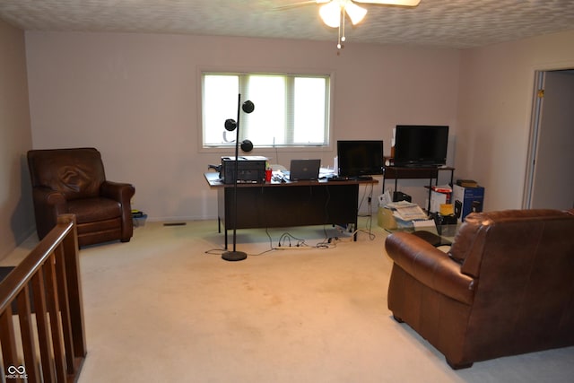 office with ceiling fan, a textured ceiling, carpet floors, and baseboards