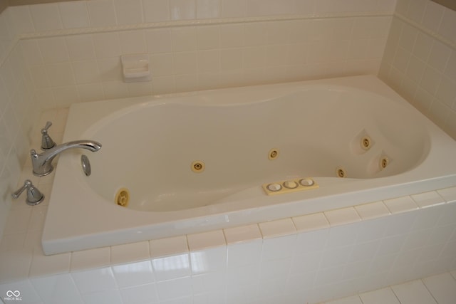 bathroom featuring a tub with jets and tile patterned flooring