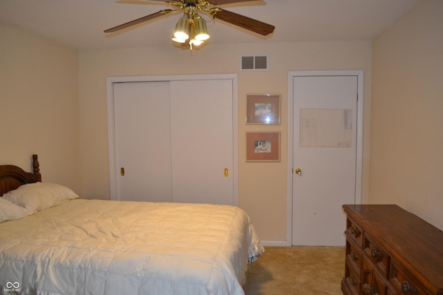 carpeted bedroom with a closet and a ceiling fan