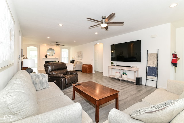 89 Kinnick Dr, Greenwood, IN 46143 - living area with a ceiling fan, arched walkways, recessed lighting, and light wood-style floors