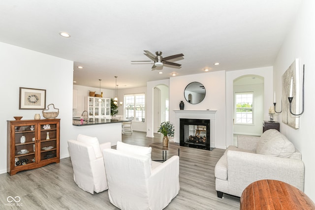 89 Kinnick Dr, Greenwood, IN 46143 - living area with arched walkways, plenty of natural light, light wood-style flooring, and recessed lighting