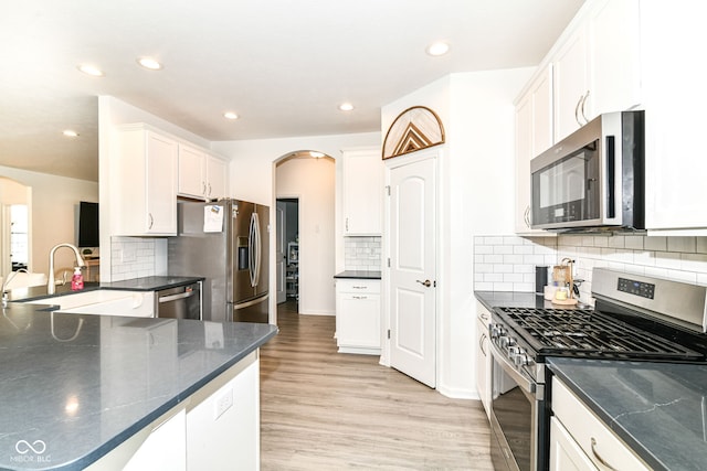 89 Kinnick Dr, Greenwood, IN 46143 - kitchen with appliances with stainless steel finishes, a sink, light wood finished floors, white cabinetry, and recessed lighting