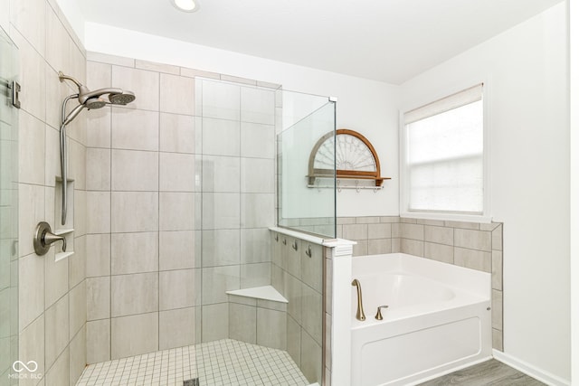 89 Kinnick Dr, Greenwood, IN 46143 - bathroom featuring a stall shower, a garden tub, and wood finished floors