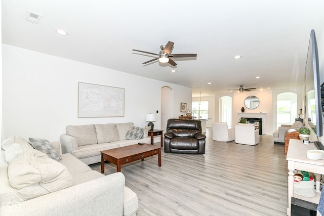 89 Kinnick Dr, Greenwood, IN 46143 - living room with arched walkways, a ceiling fan, light wood-type flooring, and recessed lighting