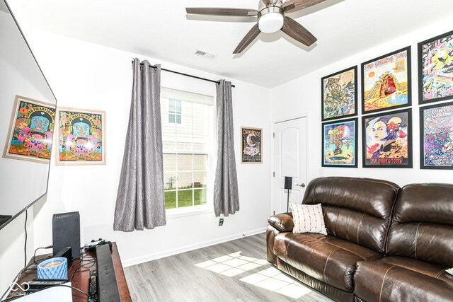89 Kinnick Dr, Greenwood, IN 46143 - living area featuring wood finished floors, a ceiling fan, healthy amount of natural light, and baseboards