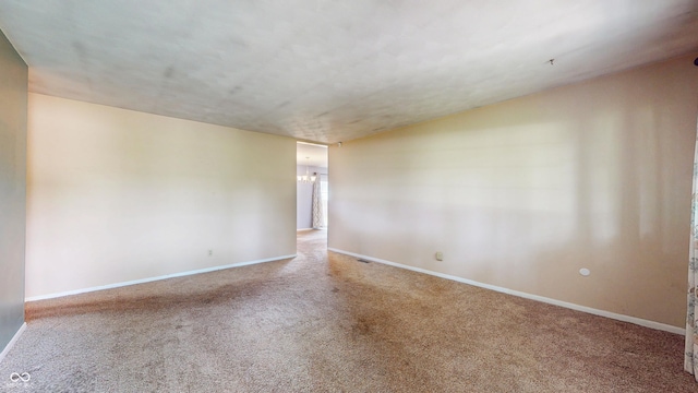 spare room with carpet and baseboards