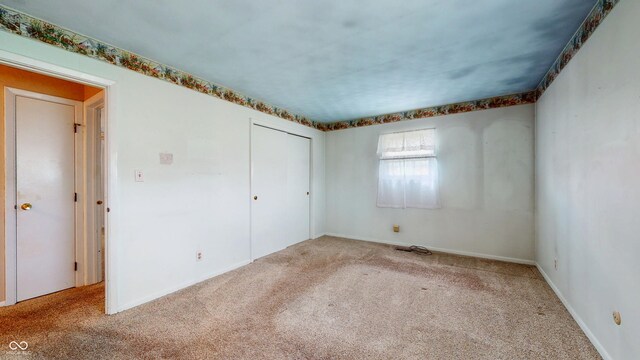 unfurnished bedroom with carpet flooring and a closet
