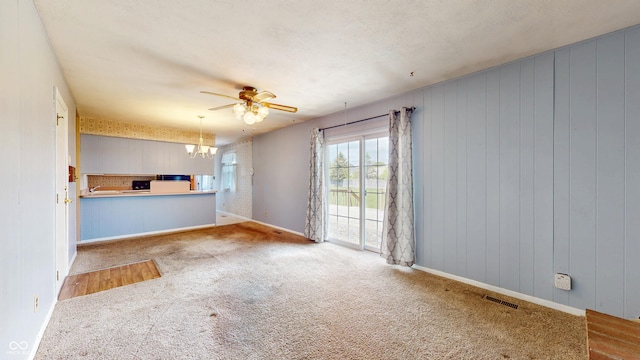 8630 E Mcgregor Rd, Indianapolis, IN 46259 - unfurnished living room featuring a chandelier, carpet floors, a ceiling fan, and baseboards