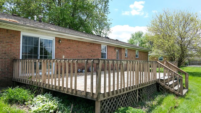 wooden deck featuring a yard