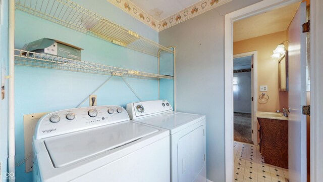 clothes washing area featuring separate washer and dryer and light floors