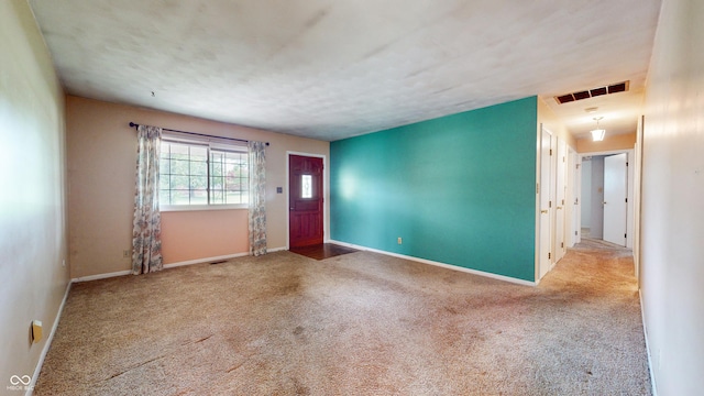 foyer entrance with carpet and baseboards