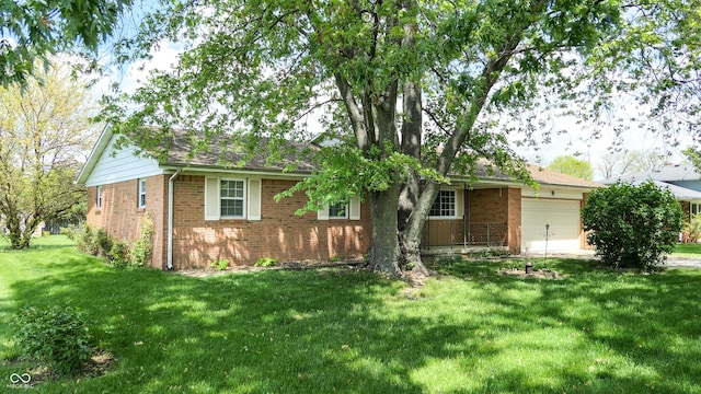 ranch-style house with an attached garage, brick siding, and a front yard