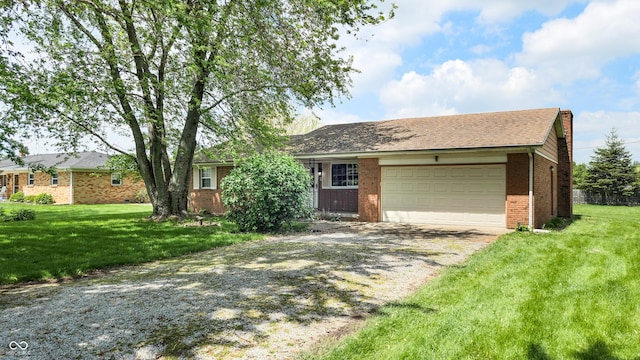 ranch-style house featuring gravel driveway, a garage, a front lawn, and brick siding