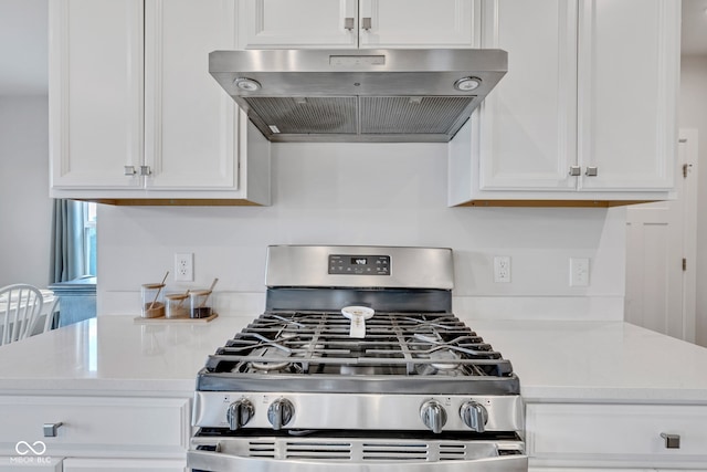 6305 Norwich Dr, Brownsburg, IN 46112 - kitchen with gas stove, under cabinet range hood, white cabinets, and light countertops