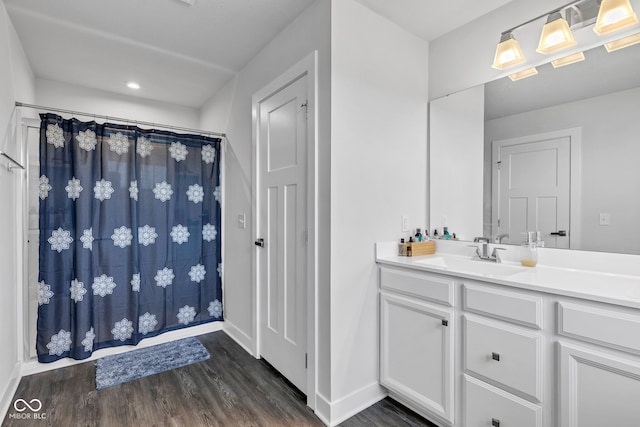 6305 Norwich Dr, Brownsburg, IN 46112 - full bath with wood finished floors, vanity, baseboards, and curtained shower
