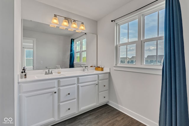 6305 Norwich Dr, Brownsburg, IN 46112 - bathroom featuring baseboards, wood finished floors, and double vanity