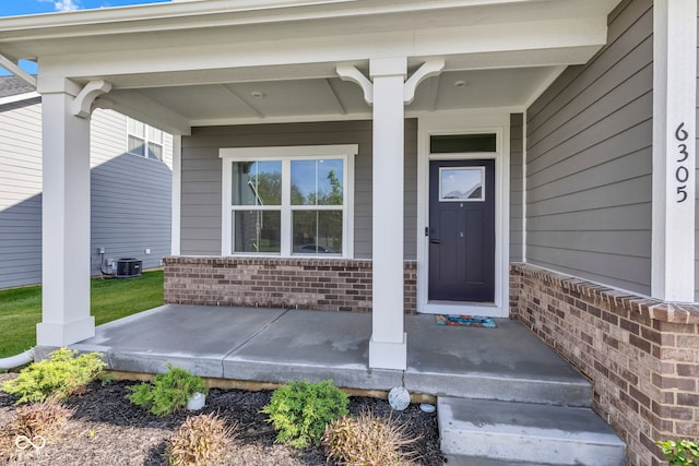 6305 Norwich Dr, Brownsburg, IN 46112 - doorway to property with covered porch, brick siding, and cooling unit