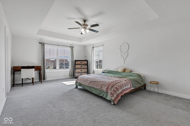 6305 Norwich Dr, Brownsburg, IN 46112 - carpeted bedroom featuring a tray ceiling, baseboards, and ceiling fan