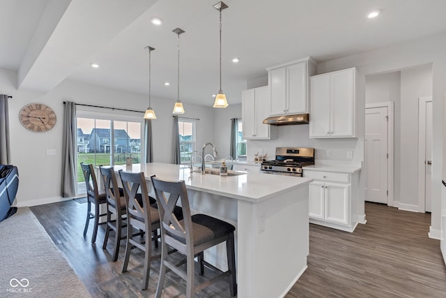 6305 Norwich Dr, Brownsburg, IN 46112 - kitchen with stainless steel gas stove, a sink, under cabinet range hood, an island with sink, and recessed lighting