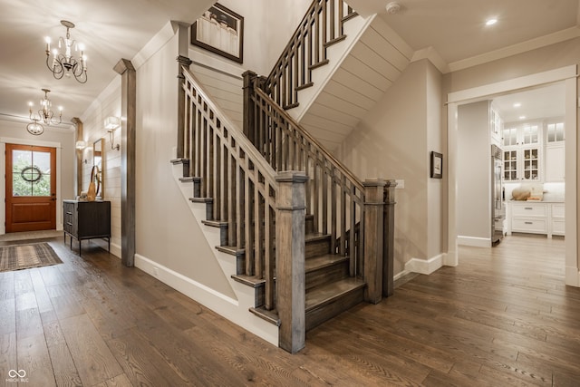 6734 W Stonegate Dr, Zionsville, IN 46077 - foyer entrance featuring ornamental molding, baseboards, a chandelier, dark wood-style floors, and stairway