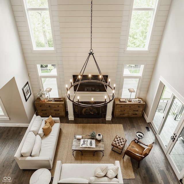 6734 W Stonegate Dr, Zionsville, IN 46077 - living room with a towering ceiling, wood finished floors, a chandelier, and baseboards