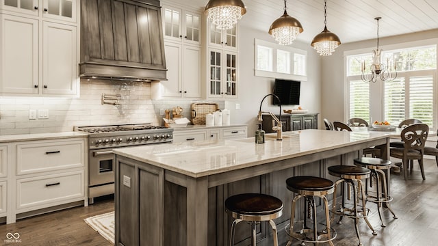 6734 W Stonegate Dr, Zionsville, IN 46077 - kitchen with custom range hood, a chandelier, double oven range, a sink, and dark wood-type flooring