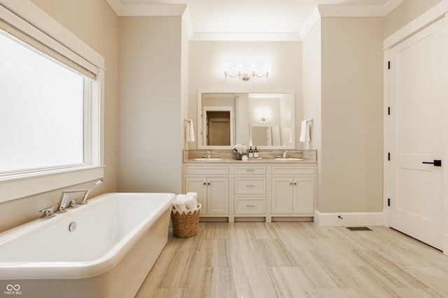 6734 W Stonegate Dr, Zionsville, IN 46077 - full bathroom featuring a freestanding bath, double vanity, crown molding, and wood finished floors