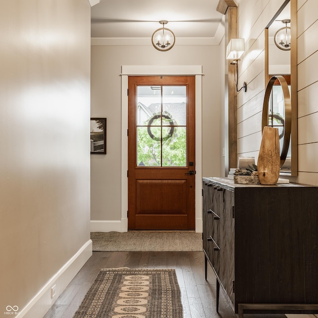 6734 W Stonegate Dr, Zionsville, IN 46077 - doorway featuring a chandelier, dark wood-style floors, crown molding, and baseboards