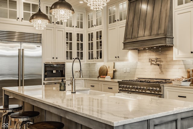 6734 W Stonegate Dr, Zionsville, IN 46077 - kitchen with custom range hood, high quality appliances, a chandelier, a sink, and tasteful backsplash