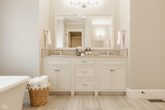 6734 W Stonegate Dr, Zionsville, IN 46077 - full bathroom featuring tasteful backsplash, ornamental molding, a chandelier, double vanity, and wood finished floors