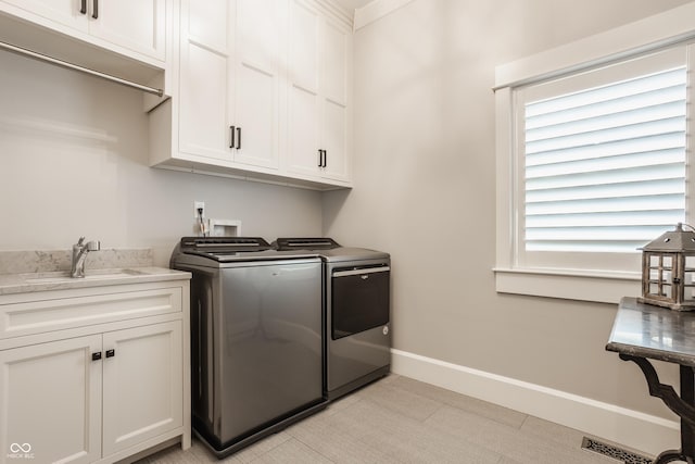 6734 W Stonegate Dr, Zionsville, IN 46077 - clothes washing area with independent washer and dryer, cabinet space, and baseboards