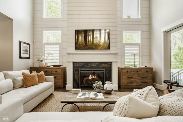 6734 W Stonegate Dr, Zionsville, IN 46077 - living room with a towering ceiling, a premium fireplace, and wood finished floors