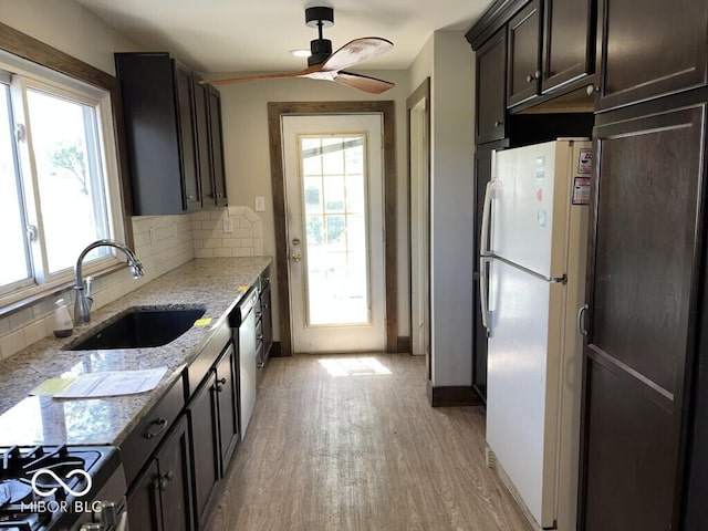 3209 Mounds Rd, Anderson, IN 46016 - kitchen featuring a sink, freestanding refrigerator, gas range, and plenty of natural light