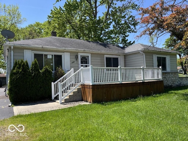 3209 Mounds Rd, Anderson, IN 46016 - view of front facade featuring a front lawn, a chimney, roof with shingles, and a wooden deck