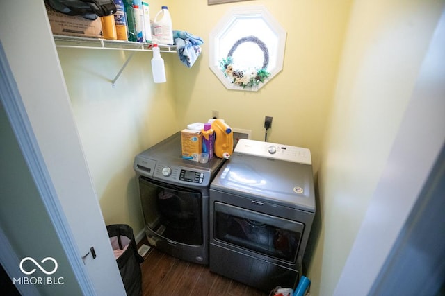 laundry area with washing machine and dryer and wood finished floors