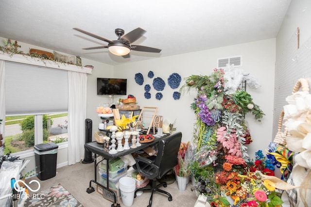 home office featuring carpet floors and a ceiling fan