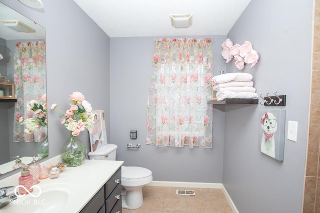 full bath featuring tile patterned floors, vanity, toilet, and baseboards