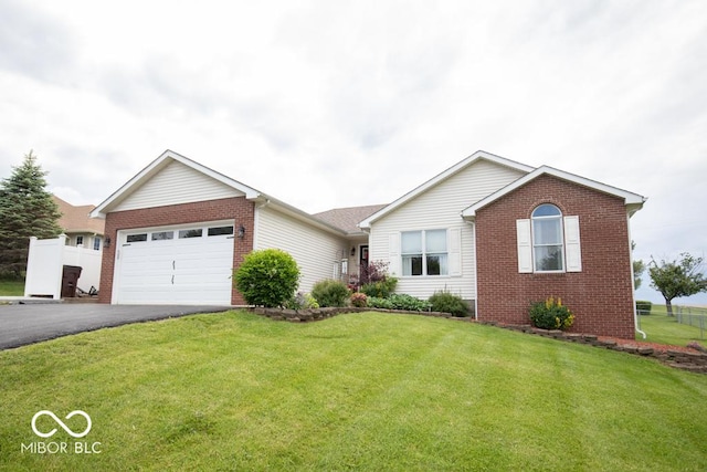 ranch-style house featuring brick siding, driveway, and an attached garage