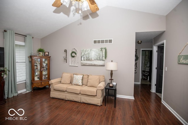 living room featuring wood finished floors, vaulted ceiling, a ceiling fan, and baseboards