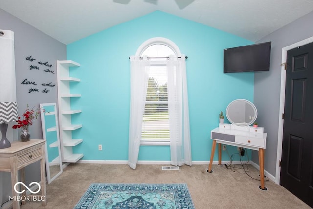 carpeted bedroom featuring lofted ceiling and baseboards