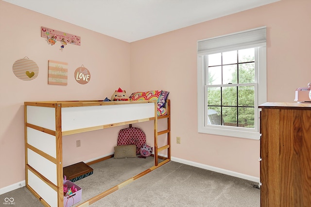 bedroom with carpet floors, multiple windows, and baseboards