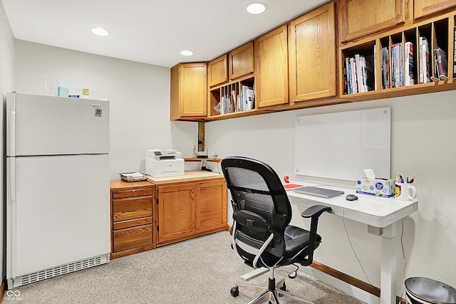 home office featuring built in study area, recessed lighting, and light colored carpet