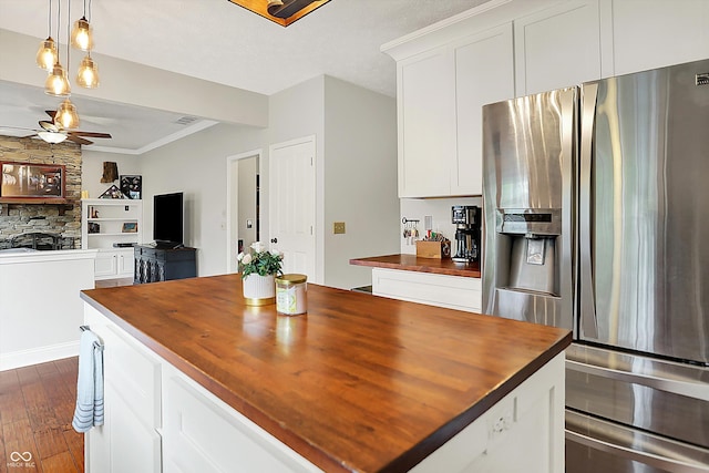 kitchen with stainless steel fridge, wooden counters, ceiling fan, dark wood finished floors, and white cabinetry