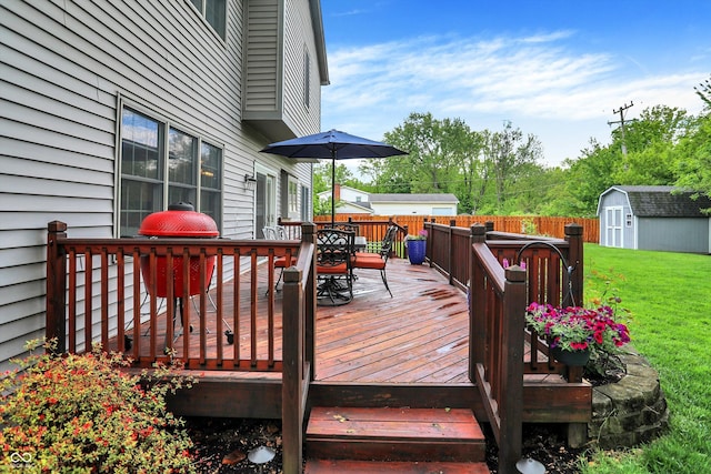 deck featuring a storage shed, outdoor dining area, and an outdoor structure